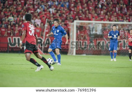NONTHABURI THAILAND- MAY 10 : A.Nakamura (blue) in action during the AFC CUP Group G between Muang Thong UTD vs Tampines Rovers Fc on May 10, 2011 at Yamaha Stadium in Nonthaburi, Thailand