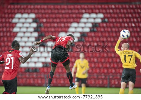 NONTHABURI, THAILAND - MAY 25: M.Christian (red) in action during the AFC CUP between Muang Thong UTD vs Al Ahed Fc on May 25, 2011 at Yamaha Stadium in Nonthaburi, Thailand