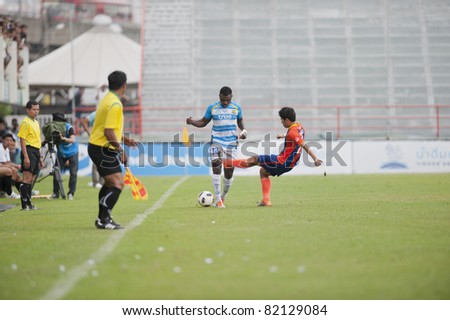 BANGKOK THAILAND- JULY 30 :P.Ekollo (B) in action during Thai Premier League (TPL) between thai port fc (Orange) vs Pattaya Utd. (Blue) on July 30, 2011 at PAT Stadium in Bangkok Thailand