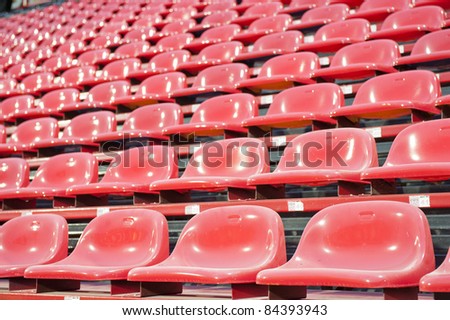 Rows of red football stadium seats with numbers.