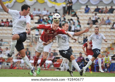 BANGKOK THAILAND - JANUARY 15 : C.Makinok (red) in action during KING\'S CUP 2012 between Denmark vs Norway on January 15, 2012 in Rajamangla Stadium,Bangkok, Thailand.