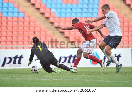 BANGKOK THAILAND - JANUARY 15 : M.Patrick (red) in action during KING\'S CUP 2012 between Denmark vs Norway on January 15, 2012 in Rajamangla Stadium,Bangkok, Thailand.
