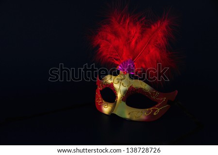 he/she chewed of golden carnival with red feathers on dark bottom