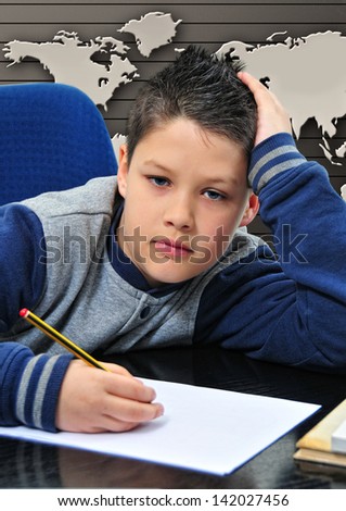 boy, with pencil, and paper writing with map bottom
