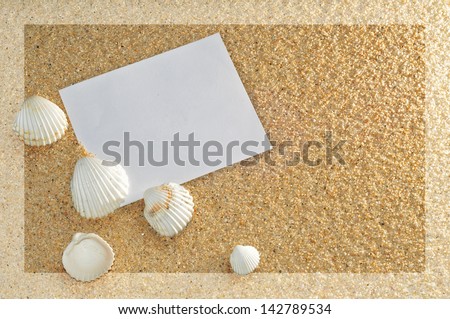 bottom of sand with paper leaf and shells of white color