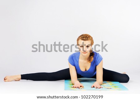 Beautiful sporty woman doing stretching exercise
