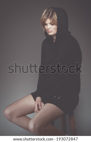 Young sad woman in black hood