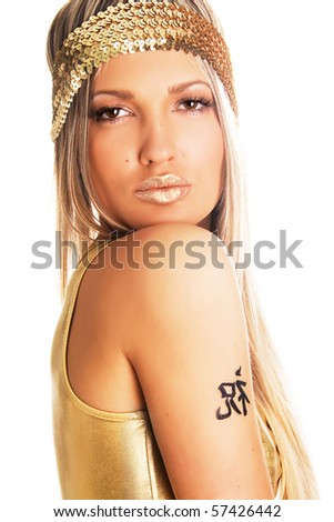 pretty girl tattoos. stock photo : Pretty girl in golden clothing with tattoo on a shoulder