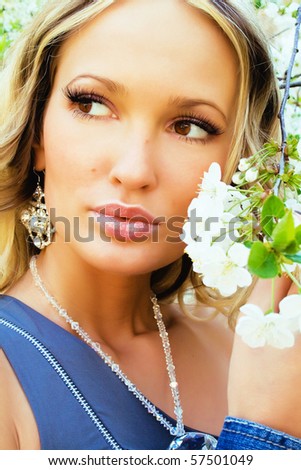 Portrait of a pretty woman with cherry tree flowers