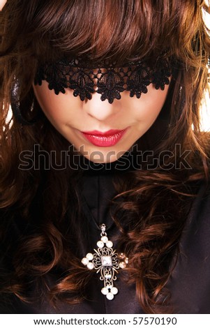 brilliant brunette hairstyle. stock photo : Portrait of a beautiful mysterious brunette with a brilliant crucifix