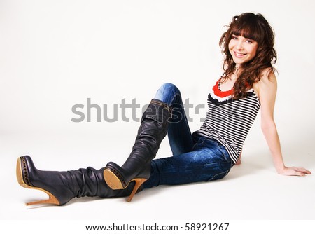 Pretty cheerful model in leather high boots