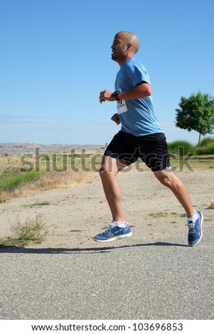 BAKERSFIELD, CA - MAY 26:  An unidentified male contestant finds the pace fast and the weather hot during the Running Xrew Invite 5k race on May 26, 2012, at Bakersfield, California.