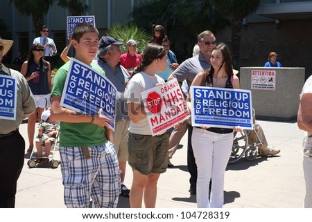 BAKERSFIELD, CA - JUN 8: Unidentified participants show protest signs at the Stand Up for Religious Freedom Rally to object to the HHS health care mandate on June 8, 2012,  in Bakersfield, California.