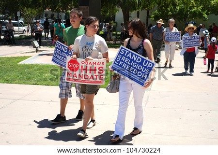 BAKERSFIELD, CA - JUN 8: Unidentified participants show protest signs at the Stand Up for Religious Freedom Rally to object to the HHS health care mandate on June 8, 2012,  in Bakersfield, California.