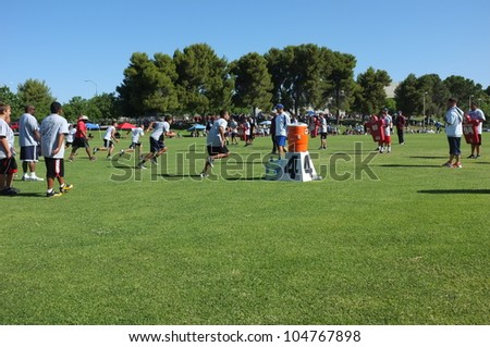 BAKERSFIELD, CA - JUNE 9: Boys sprint to get in shape for the Golden Empire Youth Football Camp at Bakersfield Community College on June 9, 2012,  in Bakersfield, California.