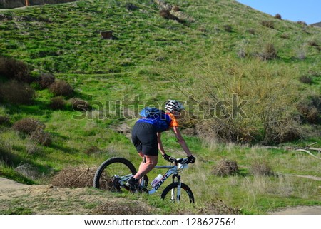 BAKERSFIELD, CA-FEB 17: An unidentified male rider bounces down a steep hill during the Foothill Classic Mountain Bike Race on February 17, 2013, in Bakersfield, California.