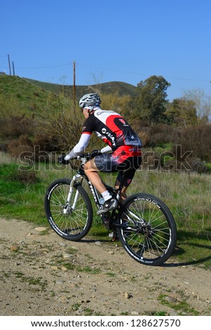 BAKERSFIELD, CA-FEB 17: An unidentified male rider powers up a steep hill during the Foothill Classic Mountain Bike Race on February 17, 2013, in Bakersfield, California.