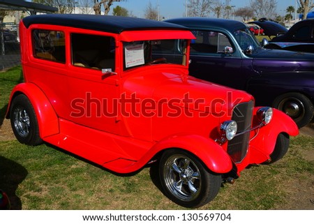 BAKERSFIELD, CA-MAR 2: A very red custom 1929 Ford Model A makes a bold statement at the Cruisin\' For A Wish Car & Motorcycle Show on March 2, 2013, in Bakersfield, California