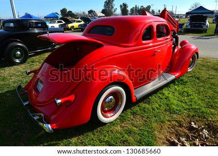 BAKERSFIELD, CA-MAR 2: Event attendees are treated to a look at this red 1936 Ford Coupe at the Cruisin\' For A Wish Car & Motorcycle Show on March 2, 2013, in Bakersfield, California.