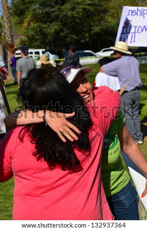 BAKERSFIELD, CA - MAR 24: Two women embrace at an impromptu reunion during a rally for a new immigration law on Cesar Chavez Day on March 24, 2013,  in Bakersfield, California.