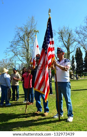 BAKERSFIELD, CA - MAR 24: Two Mexican-American veterans make up the color guard at a rally for a new immigration law on Cesar Chavez Day on March 24, 2013,  in Bakersfield, California.