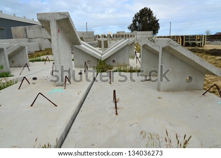 Precast concrete shapes are awaiting incorporation into a new bridge construction project