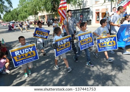 SHAFTER, CA - MAY 4: Little kids get political with their signs while marching in the Cinco de Mayo Festival parade on May 4, 2013, at Shafter, California.