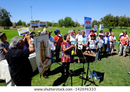 BAKERSFIELD, CA - JUN 15: Ramona Faucette, Union Organizer, sings to an activist crowd in support of a new immigration law on June 15, 2013, in Bakersfield, California.