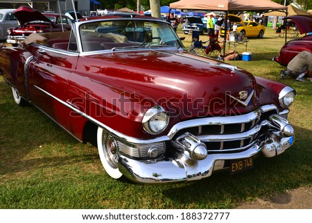BAKERSFIELD, CA-APRIL 19, 2014: A very pretty maroon 1953 Cadillac convertible vies for attention among all the cars at the Cruisin\' For A Wish Car & Motorcycle Show.