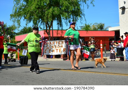 SHAFTER, CA - MAY 3, 2014: The members of the senior activities center march with enthusiasm in the Cinco de Mayo Celebration parade.