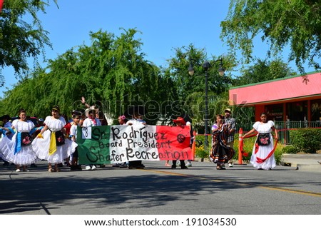 SHAFTER, CA - MAY 3, 2014: Local politics makes an appearance in the Cinco de Mayo Celebration parade with a sign by an aspirant to the recreation board presidency.