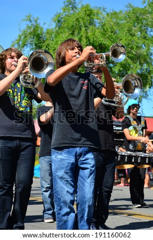 SHAFTER, CA - MAY 3, 2014: The Shafter High School band brass section plays with enthusiasm on a hot day during the Cinco de Mayo Celebration parade.