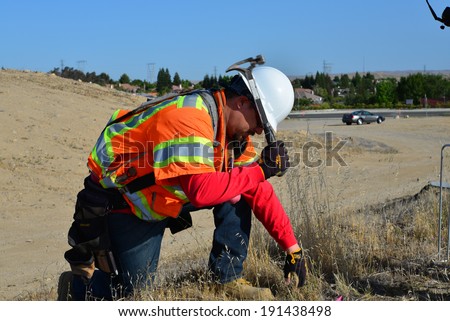 BAKERSFIELD, CA-MAY 7, 2014: Work is about 30% complete on the widening of State Route 178. David Oliveras (left) and Sam Espinosa are part of the survey crew staking lines and grades.