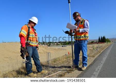 BAKERSFIELD, CA-MAY 7, 2014: Work is about 30% complete on the widening of State Route 178. David Oliveras (left) and Sam Espinosa are part of the survey crew staking lines and grades.