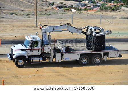 BAKERSFIELD, CA-MAY 7, 2014: As work nears 30% completion on the project to widen State Route 178 a service truck brings giant replacement tires for heavy equipment.