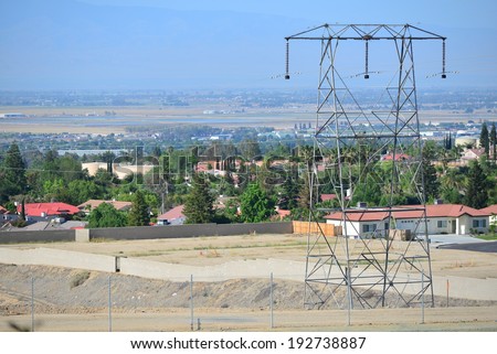 High voltage transmission lines occupy the utility company\'s right-of-way leading into the city.