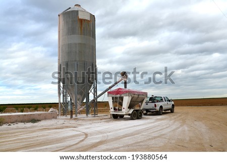 A Central California farm trailer is loaded with gypsum from a silo in order to protect and enrich soil.