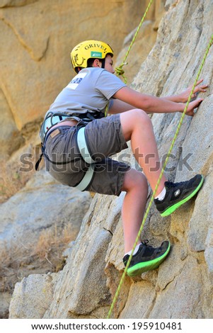 KERN COUNTY, CA-MAY 31, 2014: Teen students from Olive Knolls Christian School are getting climbing instruction today. First to go is Stevie Hall, making it look (almost) easy.