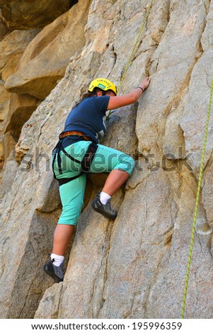 KERN COUNTY, CA-MAY 31, 2014: Isabel Pomgran is one of several teenage students from Olive Knolls Christian School who are building confidence by getting climbing instruction today.