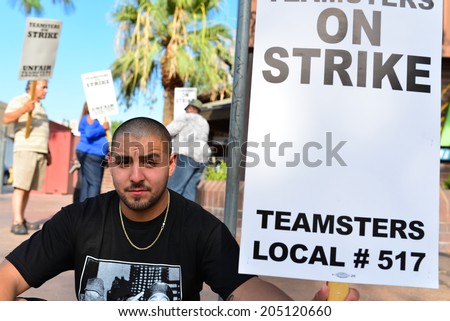 BAKERSFIELD, CA-JULY 15, 2014: After six months failed negotiations the teamsters union strikes the Golden Empire Transit District. An unidentified union member takes a break from the extreme heat.