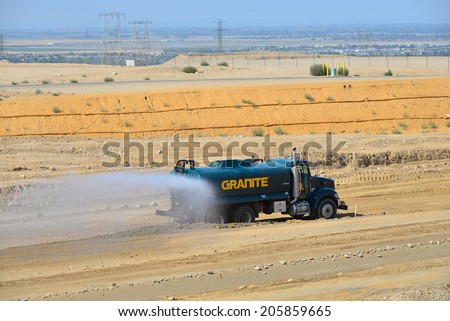 BAKERSFIELD, CA-JULY 18, 2014: This water truck is kept busy during the project to widen State Route 178 so that airborne dust is held to a minimum.