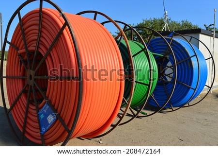 SHAFTER, CA-AUGUST 1, 2014: Colorful reels of new plastic conduit are on a construction job site, ready for direct burial in a trench for a city project.