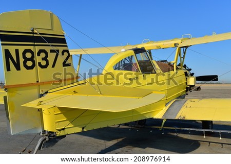 SHAFTER, CA - AUGUST 1, 2014: This Grumman Ag Cat is temporarily off duty. Crop dusters like this one provide aerial application service to the surrounding agricultural community.