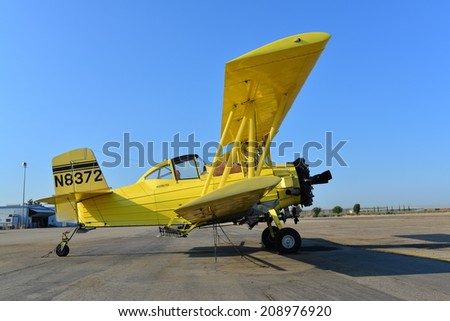 SHAFTER, CA - AUGUST 1, 2014: This Grumman Ag Cat is temporarily off duty. Crop dusters like this one provide aerial application service to the surrounding agricultural community.