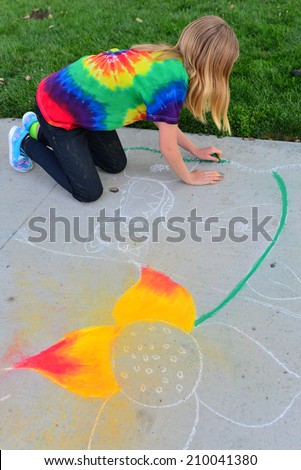 TEHACHAPI, CA - AUGUST 9, 2014: Many elementary school students have turned out for the annual Chalk on the Walk art contest. Zoe Ashton covers a lot of territory making her chalk drawing.