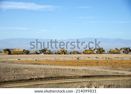 BAKERSFIELD, CA-AUGUST 31, 2014: Work on State Route 178 has temporarily stopped for the Labor Day weekend. A line of motor scrapers and heavy equipment await the resumption of the project