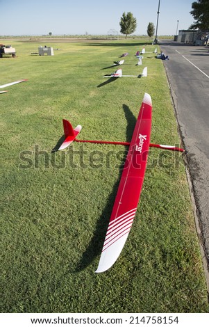 BAKERSFIELD, CA-AUGUST 24, 2014: Sleek radio controlled sailplanes rest on the grass, ready to fly in the monthly contest hosted by the Southern San Joaquin Soaring Society.