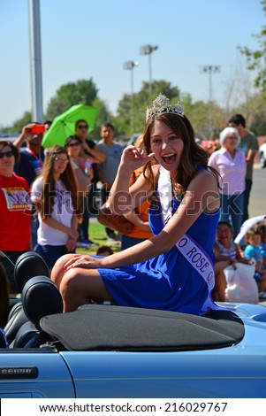WASCO, CA-SEPTEMBER 6, 2014: Morgan Campbell was last year\'s Rose Queen. She takes her final ride in the annual Festival of Roses parade prior to relinquishing her crown to this year\'s royalty.