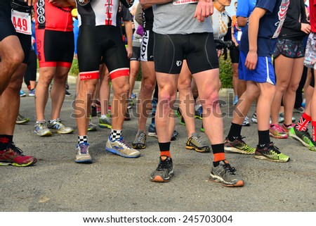 BAKERSFIELD, CA - JAN 17, 2015: Legs of all ages, sizes and condition form up at the starting line of the Rio Bravo Rumble running portion of the biathlon (running and mountain biking).