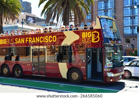 SAN FRANCISCO, CA - MARCH 29, 2015: Passengers riding on the top tier of a double-decker tour bus are treated to a magnificent view of the city.